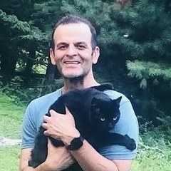 Charles Grinbaum holding his black cat